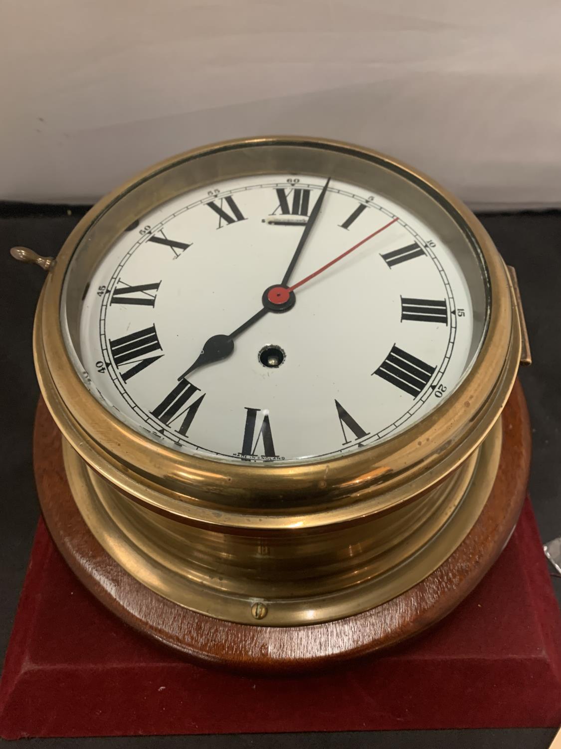 A LARGE BRASS SHIP'S CLOCK WITH KEY - 20CM DIAMETER