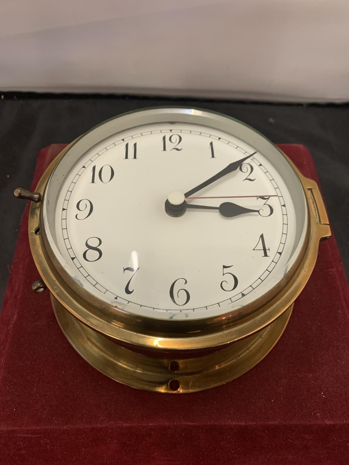 A BRASS SHIPS CLOCK WITH INSCRIPTIONS ON THE REVERSE DIAMETER:15CM