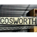 AN ILLUMINATED 'COSWORTH' SIGN