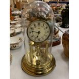 A BRASS 'KUNDO' KIENINGER & OBERGFELL MANTEL CLOCK UNDER A GLASS DOME