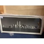 A SATIN SILVER FRAMED BLACK AND WHITE PHOTOGRAPH OF NEW YORK TWIN TOWERS