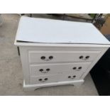 A WHITE PAINTED THREE DRAWER CHEST SUPPLIED BY ASTON & SONS