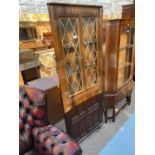 AN OAK PRIORY CORNER CABINET WITH GLAZED AND LEADED UPPER PORTION, 26" WIDE