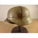 A GERMAN WORLD WAR II PERIOD STEEL HELMET WITH LEATHER LINER, LATER PAINT