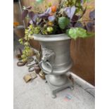 A LARGE DECORATIVE METAL URN PLANTER ON PEDESTAL BASE TO ALSO INCLUDE ARTIFICIAL FLOWERS