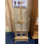 A SMALL WOODEN TABLE EASEL APPROXIMATELY 80CM X 28CM