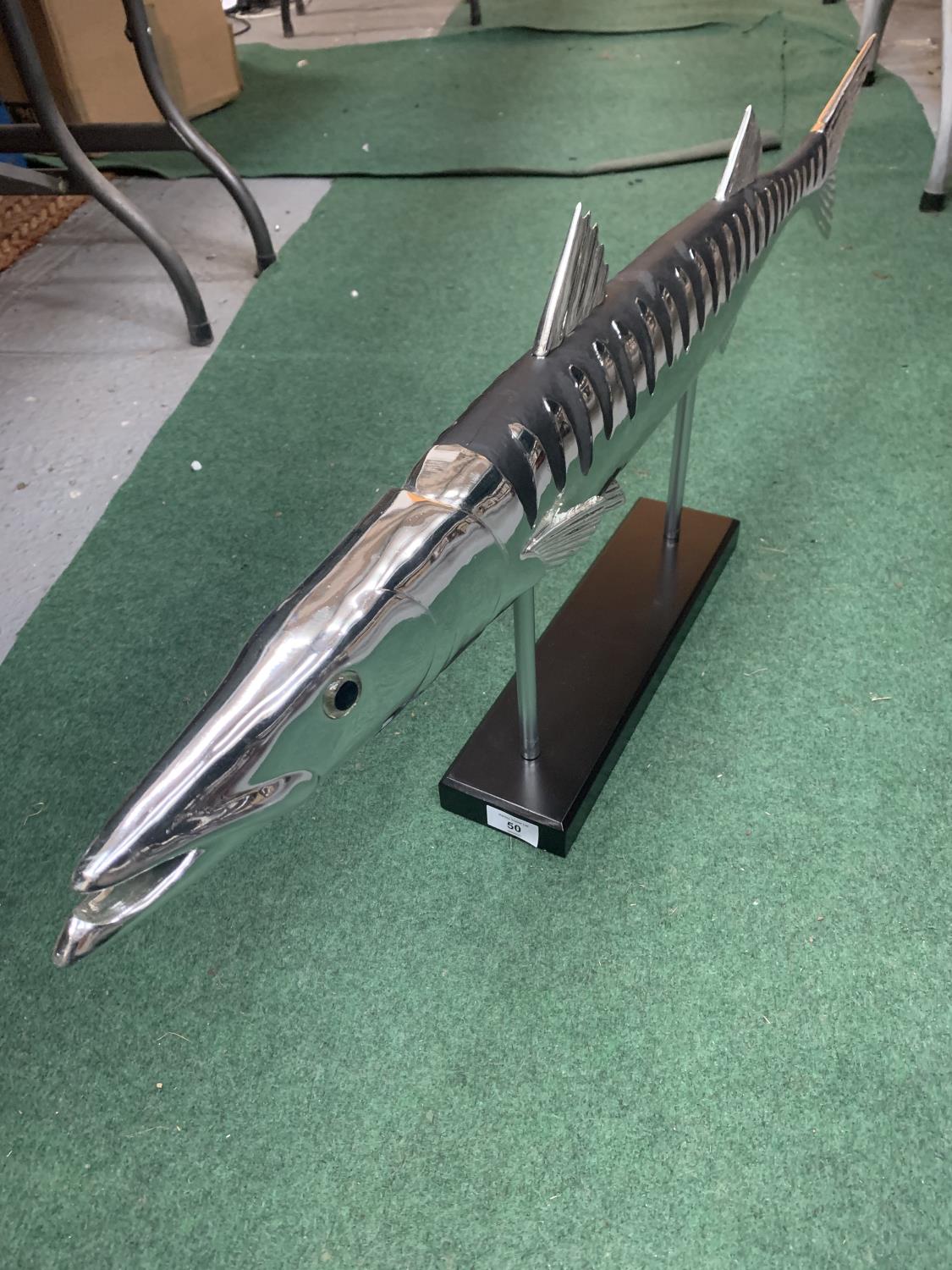 A CHROME BARRACUDA FISH ON STAND