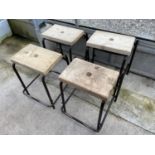 FOUR TUBULAR STACKING STOOLS