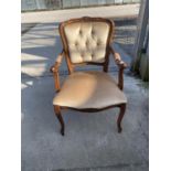 A CONTINENTAL STYLE OPEN ARMCHAIR