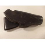 A BLACK LEATHER TRAINING HOLSTER FOR A SMITH & WESSON PISTOL