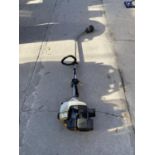 A RYOBI PETROL GRASS STRIMMER