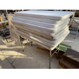 A QUANTITY OF 11 FOLDING PLASTIC TRESTLE TABLES WITH METAL LEGS