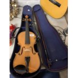 A HALF CASE VIOLIN TO INCLUDE CHIN REST AND BOW