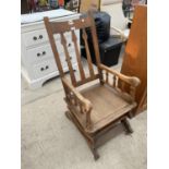 AN OAK FRAMED ART NOUVEAU ROCKING CHAIR