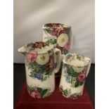 THREE FLORAL DECORATIVE JUGS ( 22CM, 18CM, 14CM)