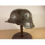 A GERMAN WORLD WAR II PERIOD STEEL HELMET WITH LEATHER LINER, LATER PAINT