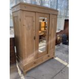 A CONTINENTAL PINE MIRROR-DOOR WARDROBE WITH TWO DRAWERS TO THE BASE, 56" WIDE