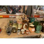 AN ASSORTMENT OF CERAMIC WARE TO INCLUDE THREE COLOURED STEINS, CHARACTER JUGS ETC
