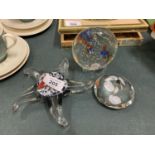 THREE GLASS PAPERWEIGHTS, ONE IN THE SHAPE OF A STAR FISH