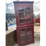 A PAINTED FULL LENGTH CORNER CUPBOARD WITH GLAZED UPPER AND LOWER DOORS