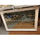 A LARGE WHITE PAINTED FRAMED BEVEL EDGE WALL MIRROR