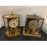 A PAIR OF GERMAN YELLOW METAL MANTEL CLOCKS