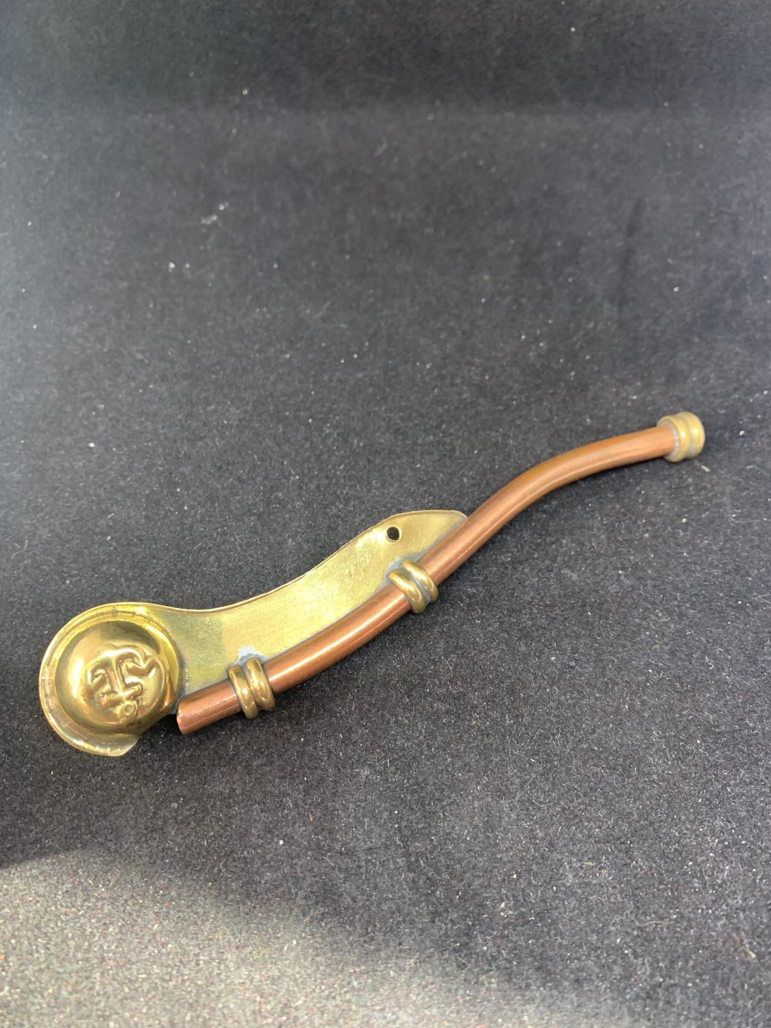 A BRASS AND COPPER BOSONS WHISTLE