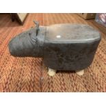 A CHILD'S FAUX LEATHER FOOTSTOOL IN THE FORM OF A HIPPOPOTAMUS