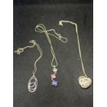 THREE SILVER NECKLACES WITH PENDANTS TPO INCLUDE A DECORATIVE HEART, A SWIRL AND A THREE COLOURED