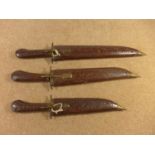 THREE INDIAN KNIVES WITH WOODEN GRIPS AND SCABBARD, SIZE OF BLADES 19CM TO 29CM