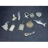 ELEVEN SILVER NECKLACE PENDANTS OF VARIOUS DESIGN