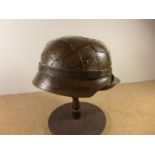 A GERMAN WORLD WAR II PERIOD STEEL HELMET WITH LEATHER LINER, LATER PAINT