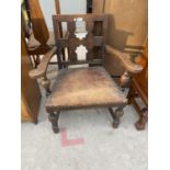 A LOW OAK JACOBEAN STYLE ELBOW CHAIR