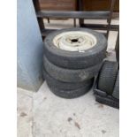 A SET OF FOUR RIMS AND TYRES OFF A MORRIS MINOR