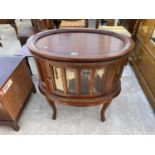 A VICTORIAN STYLE OVAL HARDWOOD DISPLAY TABLE WITH BEVEL GLASS ON OPEN BASE, WITH DETACHABLE TRAY,