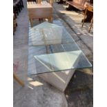 A MODERN GLASS TOPPED COFFEE TABLE, 60x30" ON TWO TRIANGULAR SHAPED POLISHED MARBLE EFFECT BASE