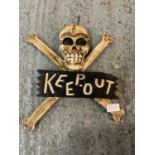 A WOODEN SKULL AND CROSS BONES 'KEEP OUT' SIGN