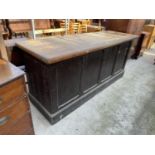 A VICTORIAN PAINTED PINE SHOP COUNTER WITH FOUR PANEL FRONT AND TWO DRAWERS WITH SCOOP HANDLES,