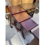 A NEST OF THREE MAHOGANY TABLES WITH BRASS CLAW FEET