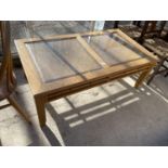 A MODERN OAK COFFEE TABLE WITH INSET GLASS TOP