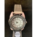 A HENLEYS FASHION WRIST WATCH WITH PINK CASE AND CLEAR STONE DIAL DECORATION IN WORKING ORDER