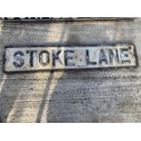 A VINTAGE CAST IRON 'STOKE LANE' ROAD SIGN