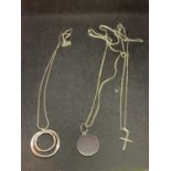 THREE SILVER NECKLACES WITH PENDANTS TO INCLUDE A CROSSAND CIRCLES