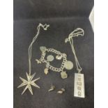 VARIOUS MARKED SILVER ITEMS TO INCLUDE AN INGOT ON A CHAIN, A CHARM BRACELET, A STAR PENDANT AND A