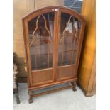A MAHOGANY DOMED TOP TWO DOOR DISPLAY CABINET WITH OPEN BASE, 34" WIDE
