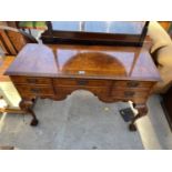 A GEORGIAN STYLE WALNUT AND CROSSBANDED LOWBOY ENCLOSING FOUR DRAWERS ON CABRIOLE LEGS, WITH BALL