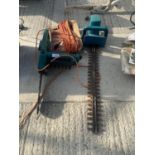 A BLACK AND DECKER ELECTRIC CHAINSAW AND HEDGE TRIMMER - BELIEVED WORKING BUT NO WARRANTY