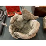 A SMALL BIRD BATH IN THE FORM OF CUPPED HANDS AND A BIRD 22CM X 25CM