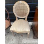 A CONTINENTAL STYLE DINING CHAIR ON TURNED AND FLUTED LEGS, WITH SPLIT CANE BACK