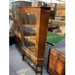 AN EDWARDIAN MAHOGANY CORNER CUPBOARD WITH GLAZED AND LEADED DOOR, SINGLE DRAWER ON OPEN BASE WITH